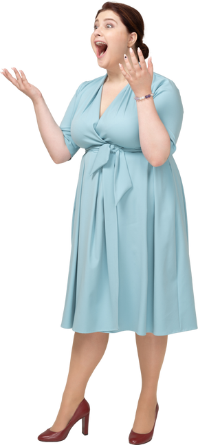 Front view of a happy woman in blue dress
