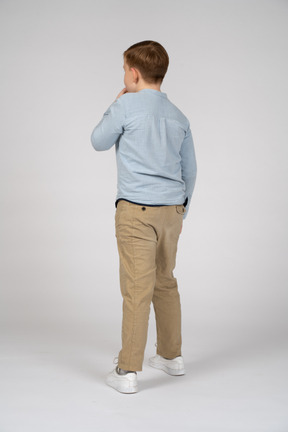 Back view of a boy whistling