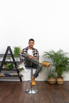 Good looking young man sitting on a chair