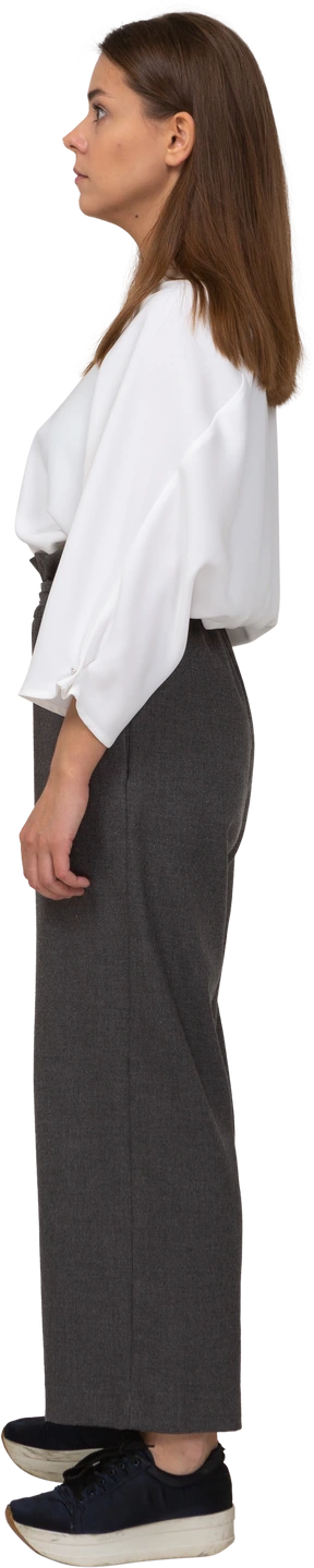 Side view of a surprised young lady in office clothing looking aside