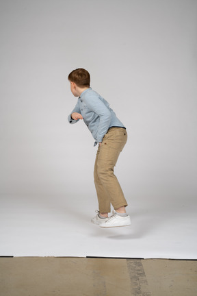 Back view of a boy in blue shirt