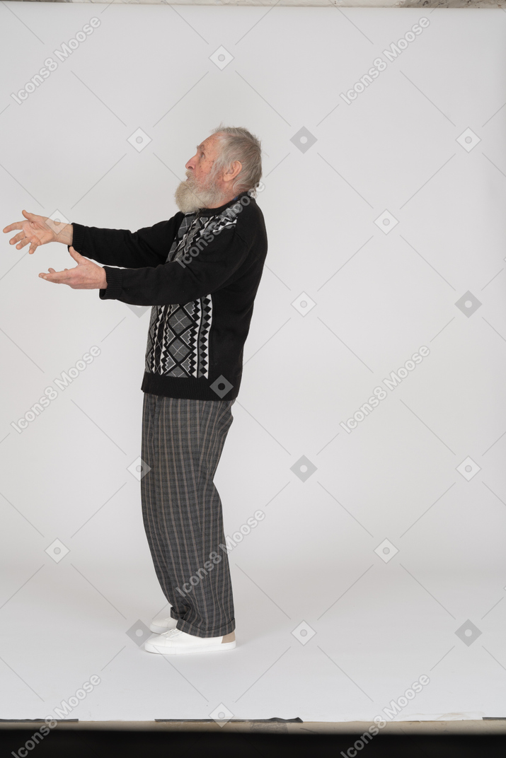 Side view of old man with outstretched arms