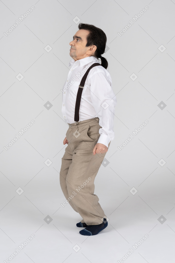 Middle-aged man in suspenders squatting