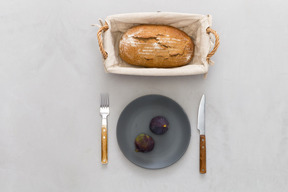 Loaf of bread and two figs on the plate