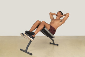 Young man working out on weight bench