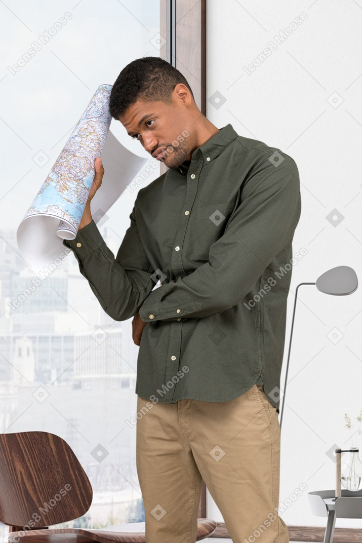 Thoughtful man holding a big paper map