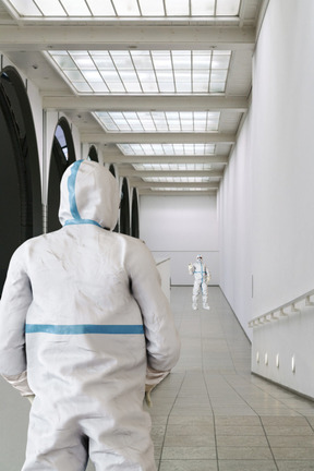 A pair of people in protective suits