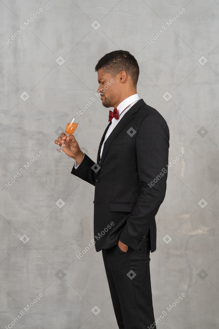 Disgusted young man looking at a glass of champagne