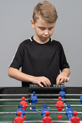 Close-up of a boy playing foosball