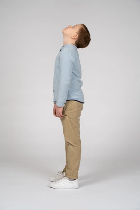 Side view of a cute boy looking up