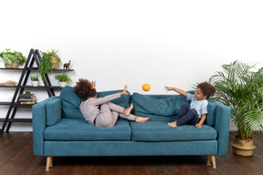 Good looking boy and girl play on the sofa