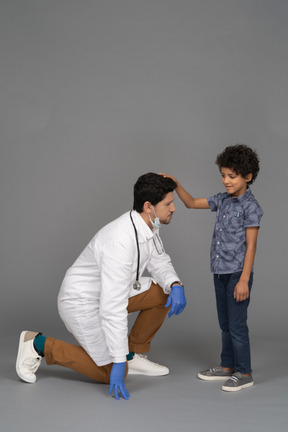 Boy putting his hand on doctor's head