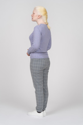 Young woman with braided hair looking away from the camera