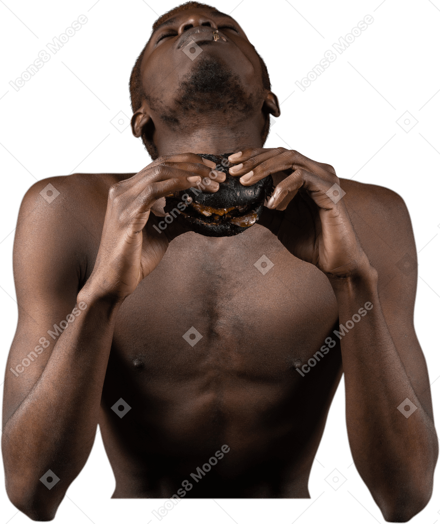 ハンバーガーを楽しんでいる若いアフロ男の正面図