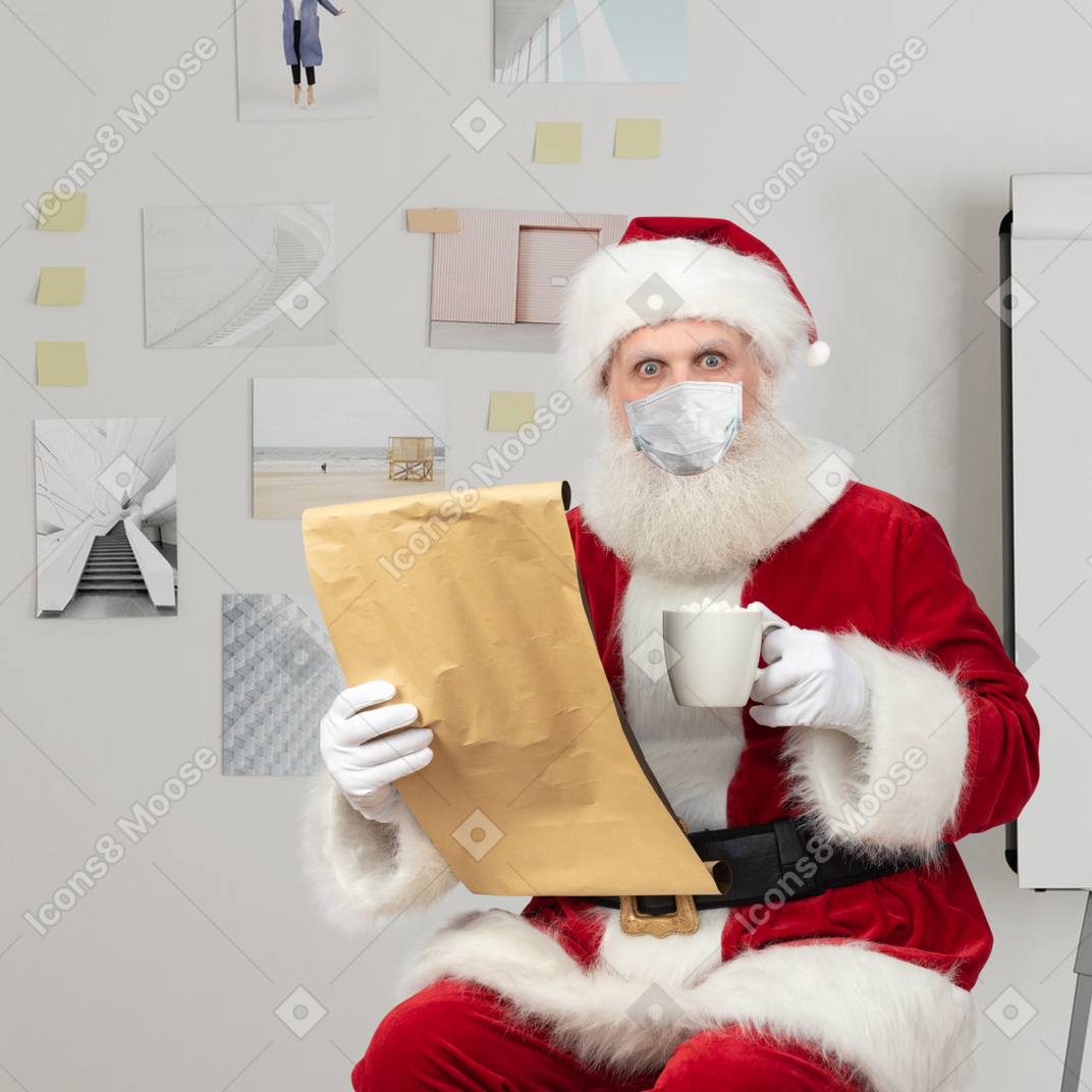 Santa wearing a mask reading gift list