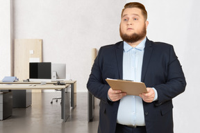 A businessman holding a clipboard in the office