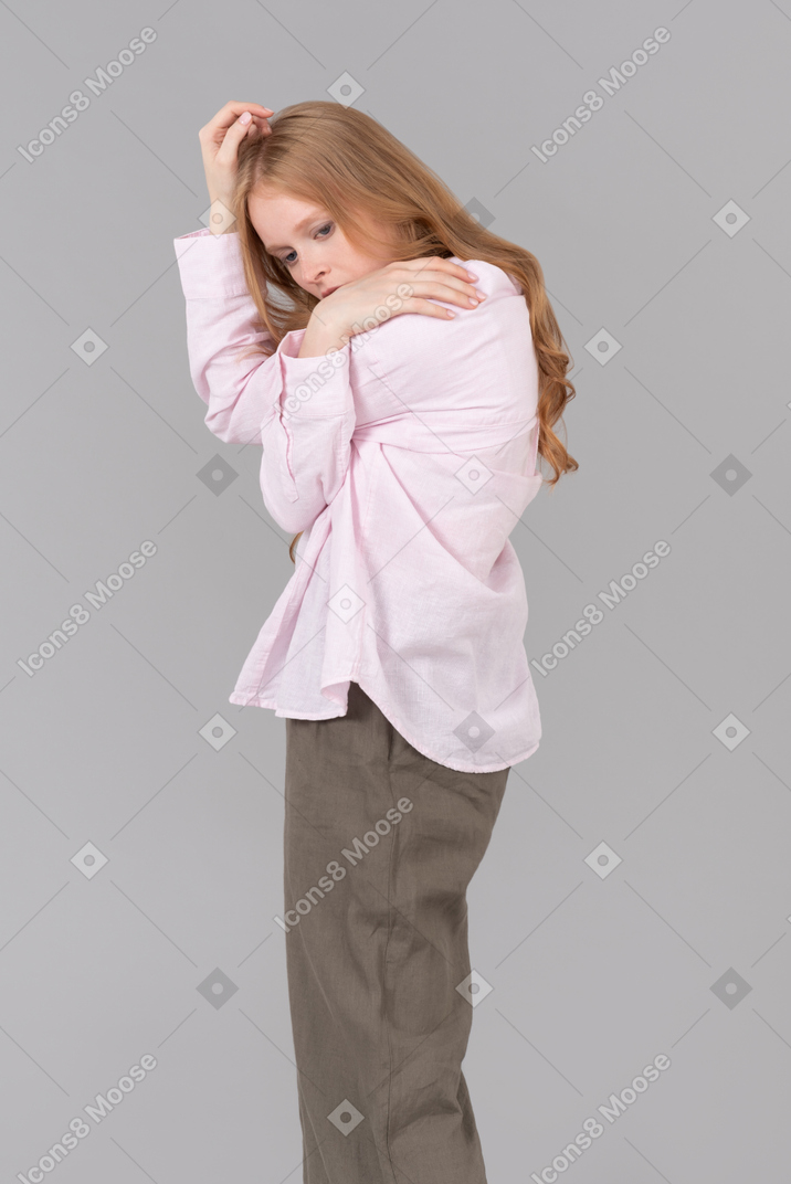 Young woman hugging herself