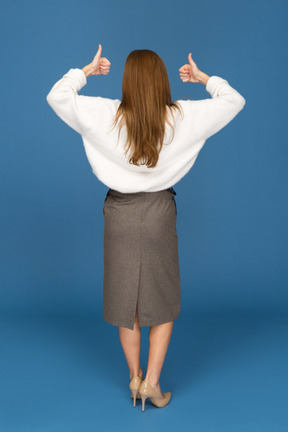 Young businesswoman giving the thumbs up