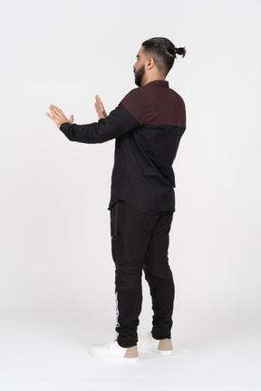 Back view of man with stop gesture