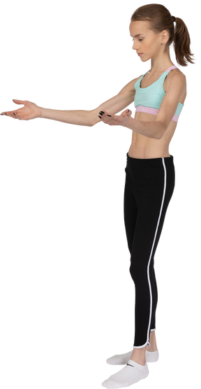 Three-quarter view of a teen girl in sportswear outstretching hands
