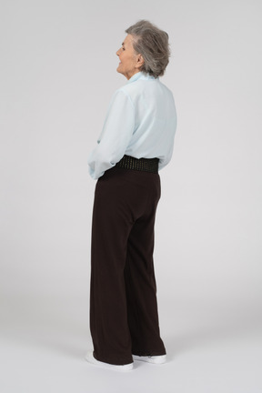 Three-quarter back view of an old woman