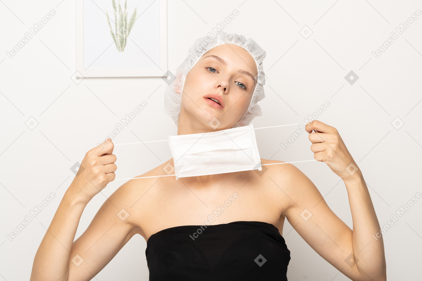 Young woman stretching mask while looking at camera