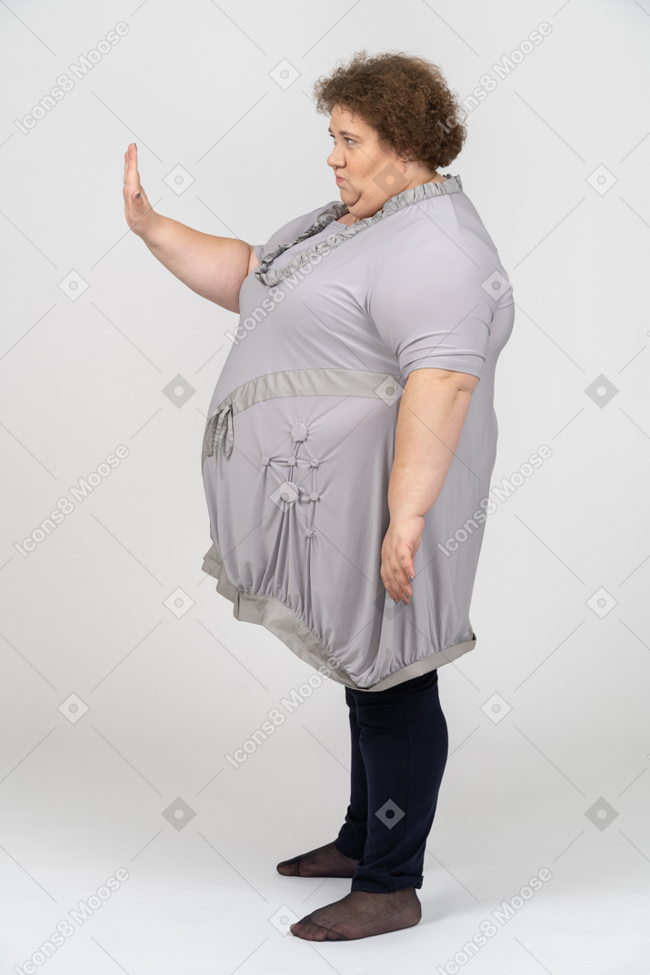 Woman showing stop gesture in profile