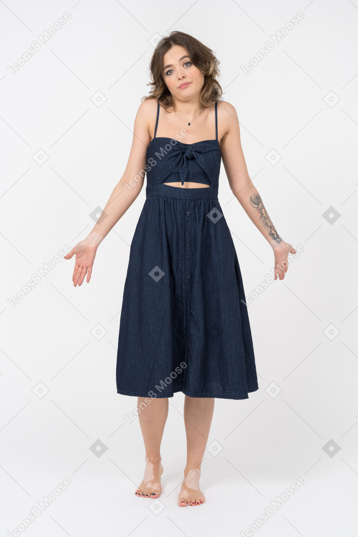Confused young woman making a helpless gesture with both hands