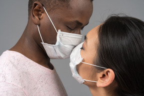 A young couple wearing face masks