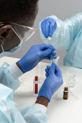 Back view of medical worker holding tube