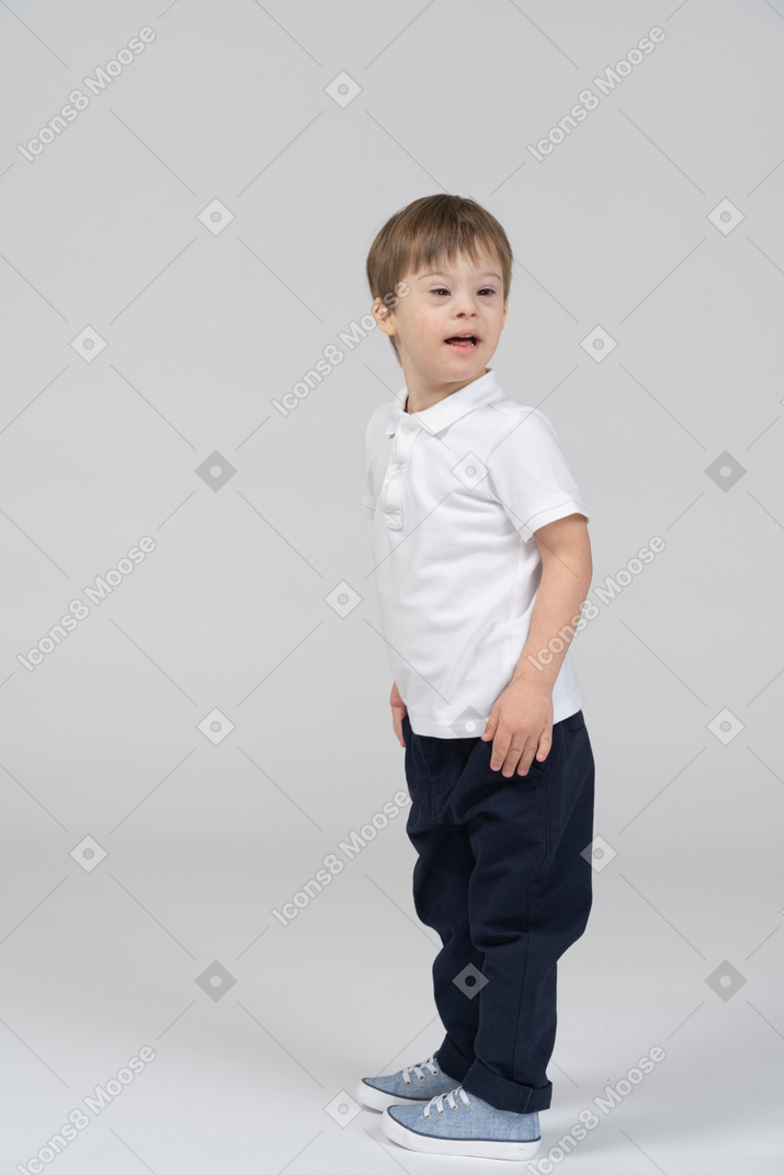 Cheerful little boy turning around