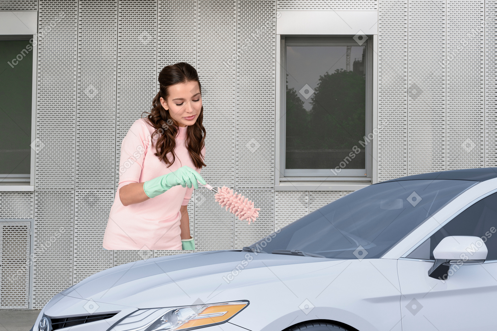 A woman in a pink shirt is cleaning a car