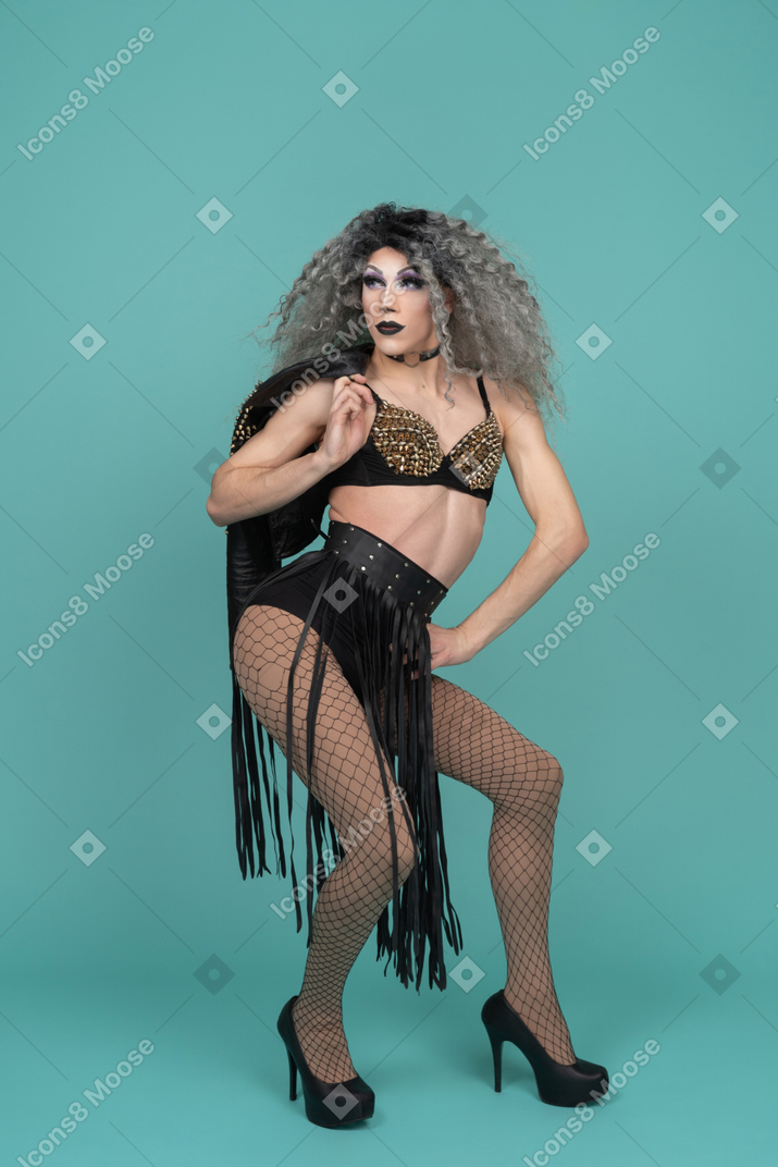 Drag queen half squatting and holding leather jacket