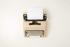 Beige typewriter on a white background