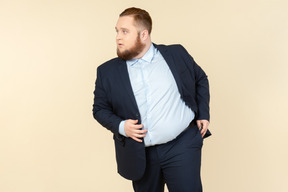 A plus-size man in a black costume with dollar bills in his hands