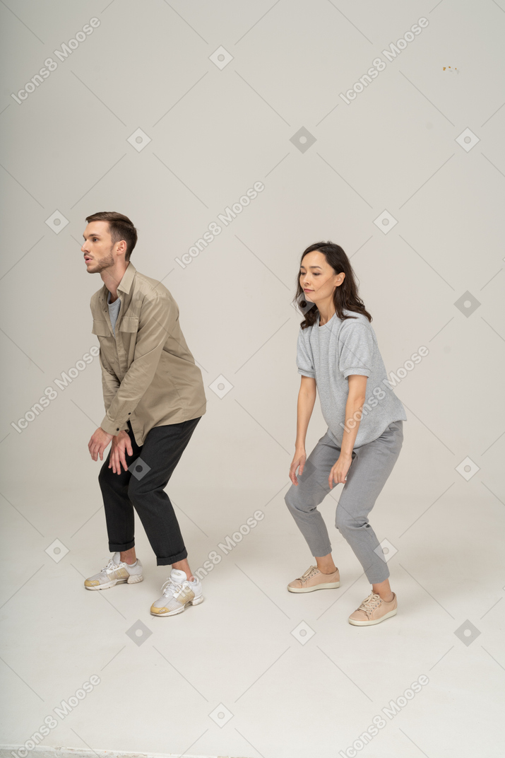 Young people doing a dance move next to each other