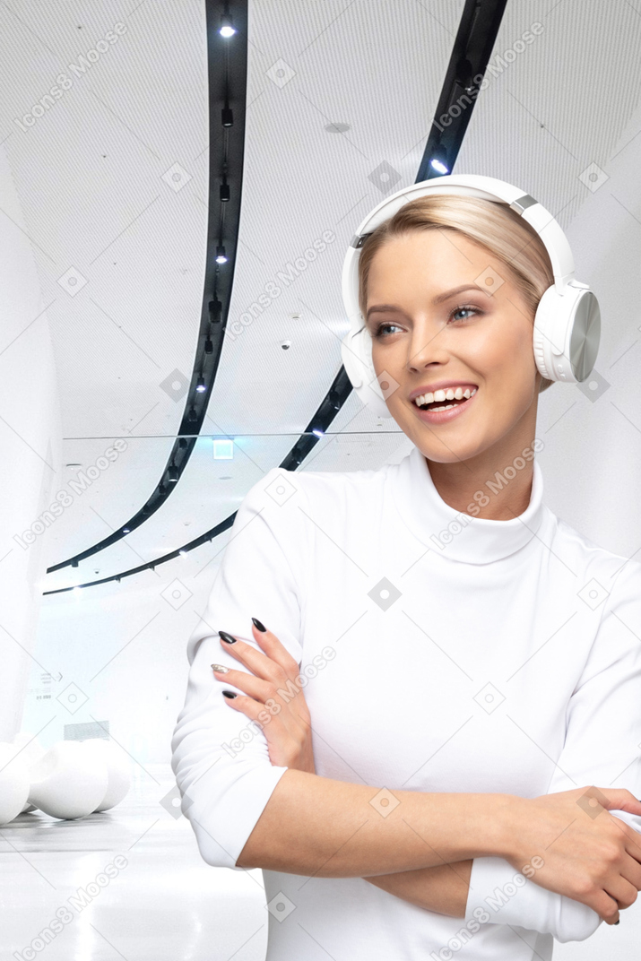 A woman wearing headphones standing in a room