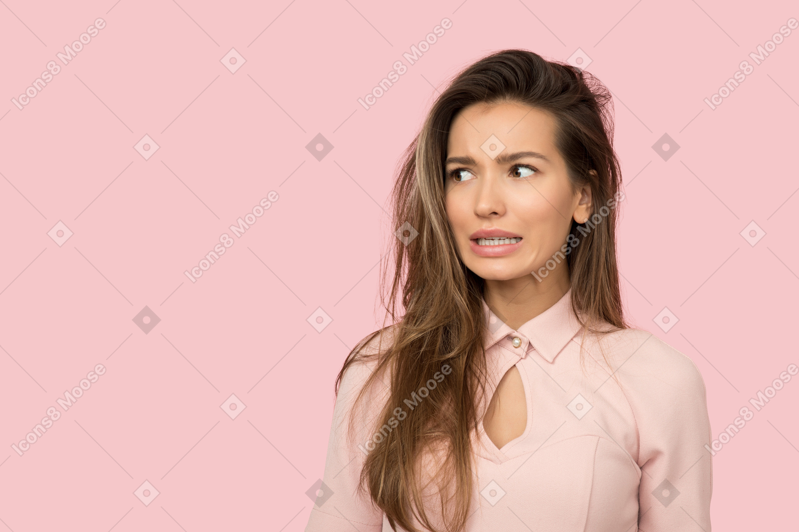 Young woman in pink looking uncomfortable