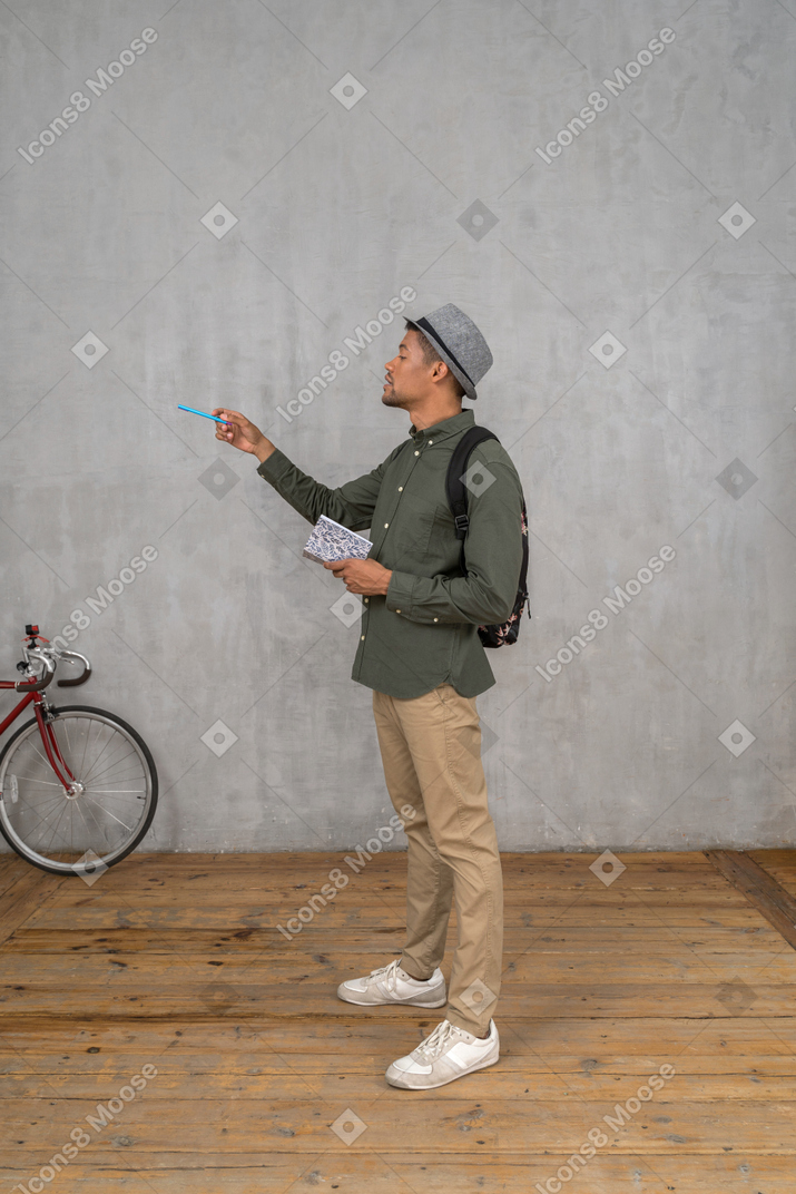 Man looking at something and taking notes