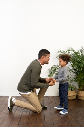 Good looking young man on knees with a boy