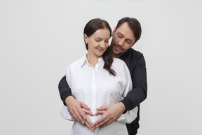 Portrait of man lovely embracing woman from behind