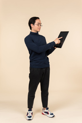 Young asian man presenting a digital tablet