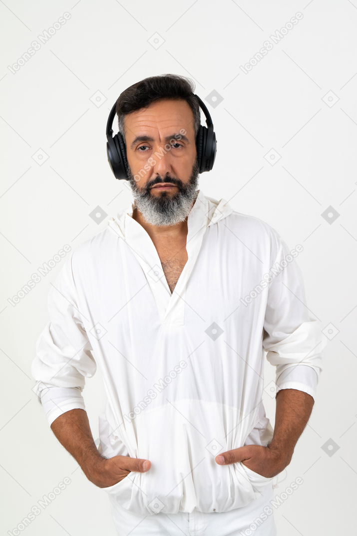 Mature man with sad face wearing headphones