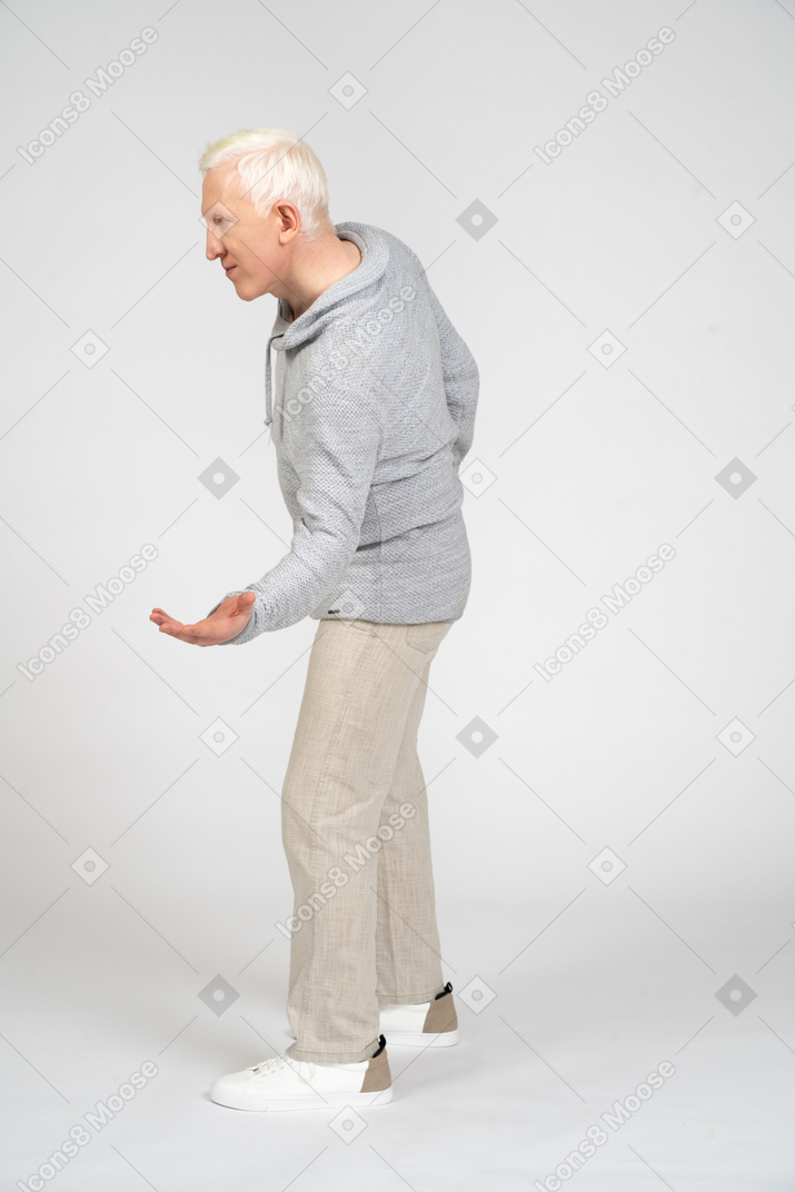 Side view of man pointing at something