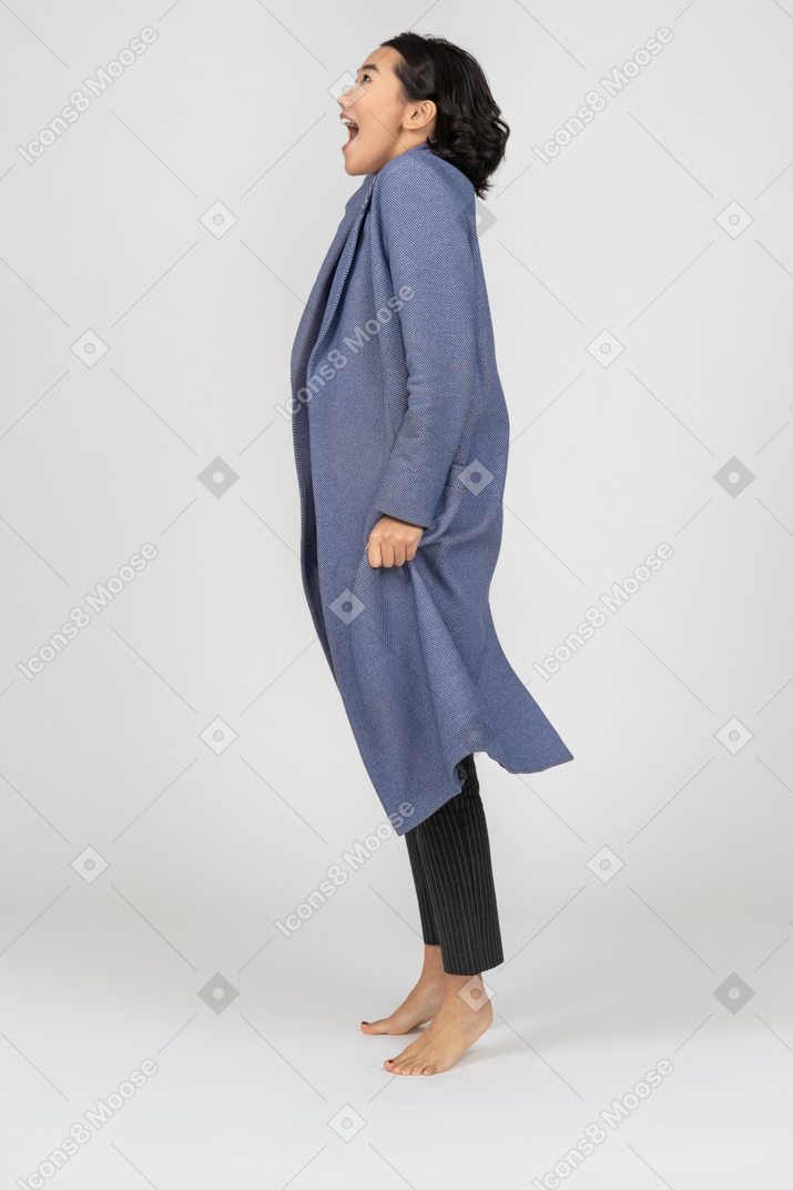 Side view of an excited woman in coat