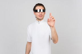 Young man in futuristic eyewear working with invisible interface