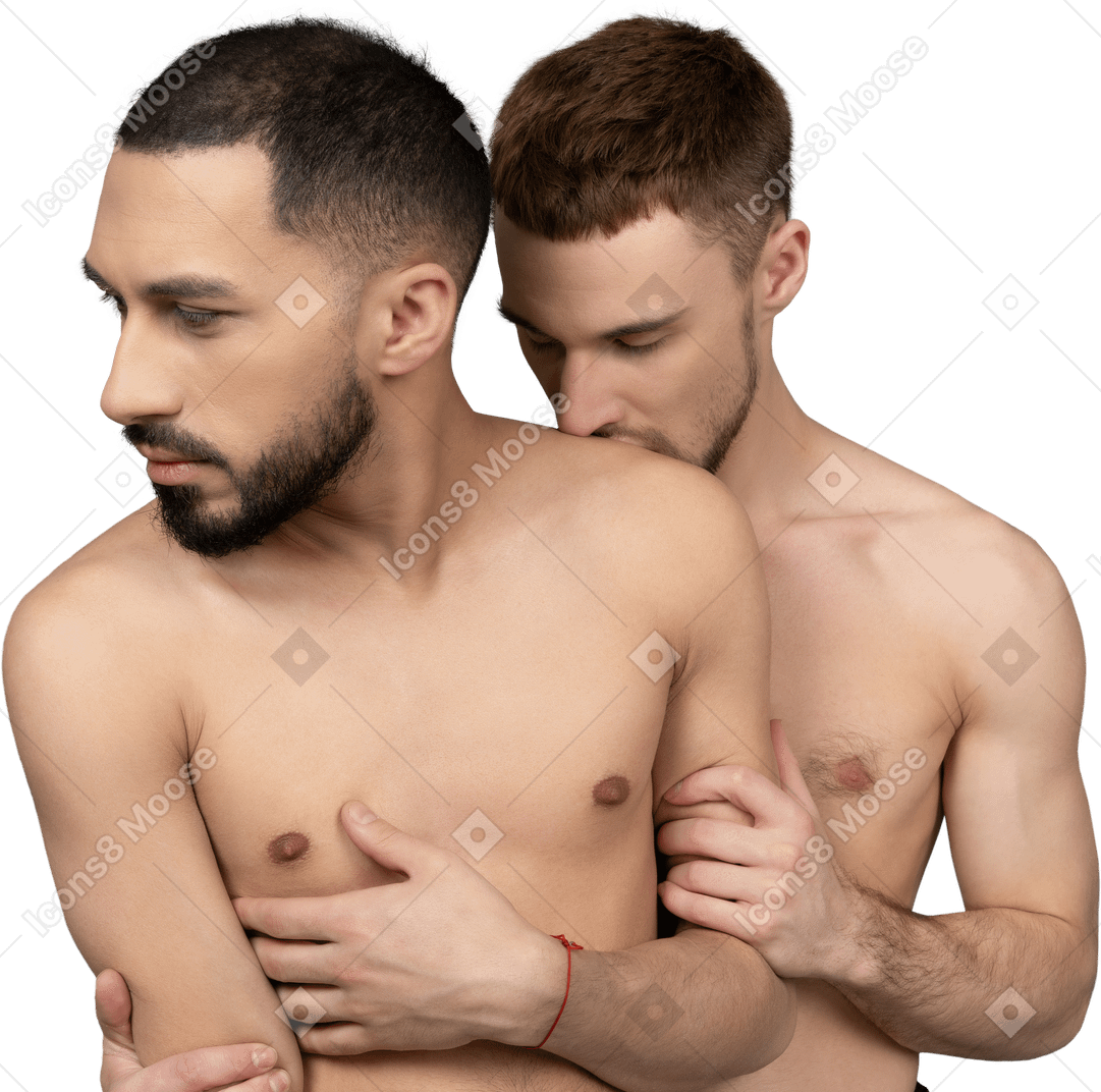 Close-up of a young caucasian man kissing shoulder of his shirtless partner from behind