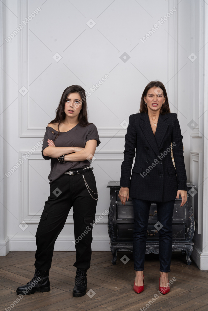Two women looking annoyed