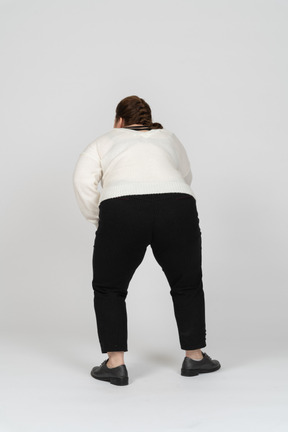 Rear view of a plus size woman in casual clothes