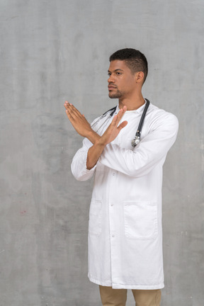 Male doctor making a stop gesture